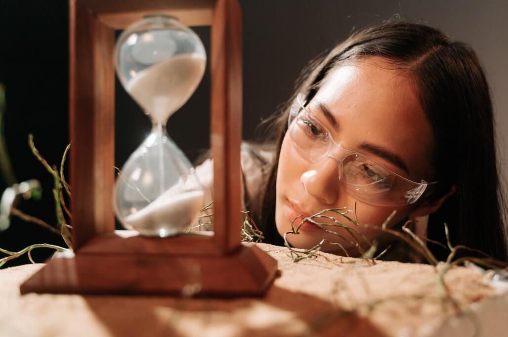 woman looking at a sandclock