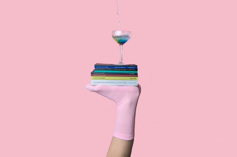 balanced books with a wine glass on top of a foot